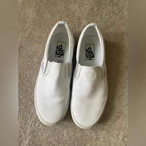 All white Vans slip-ons